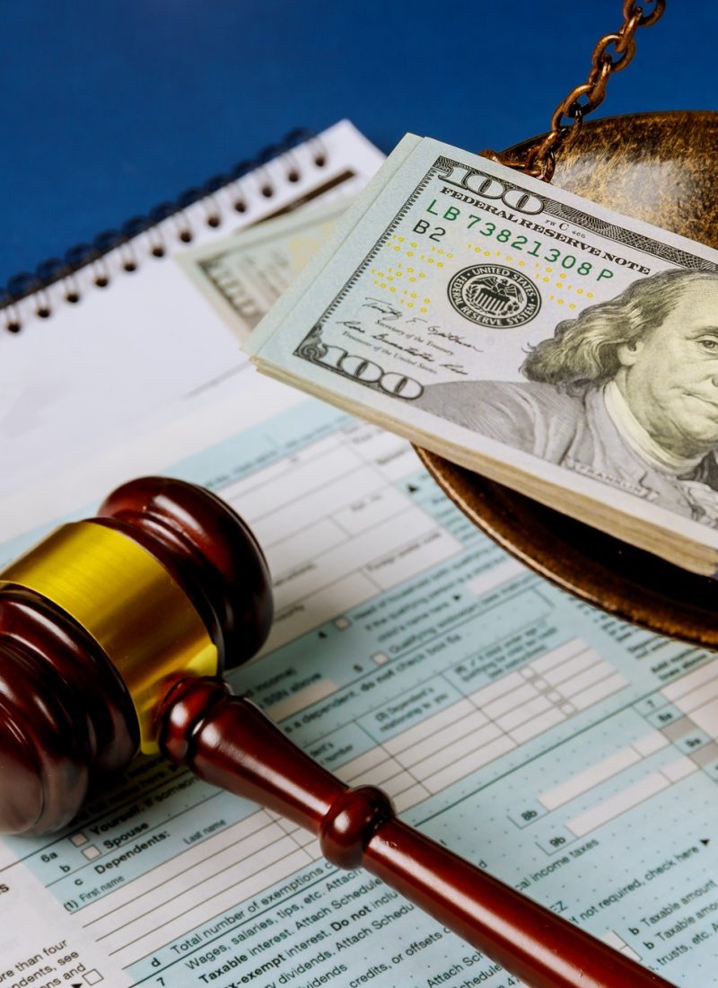 law concept scales of justice criminal liability for non payment of taxes of one hundred dollars